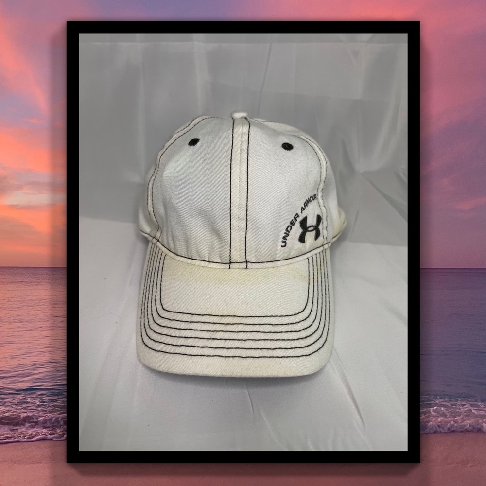 Woman’s white Under Armour baseball hat
